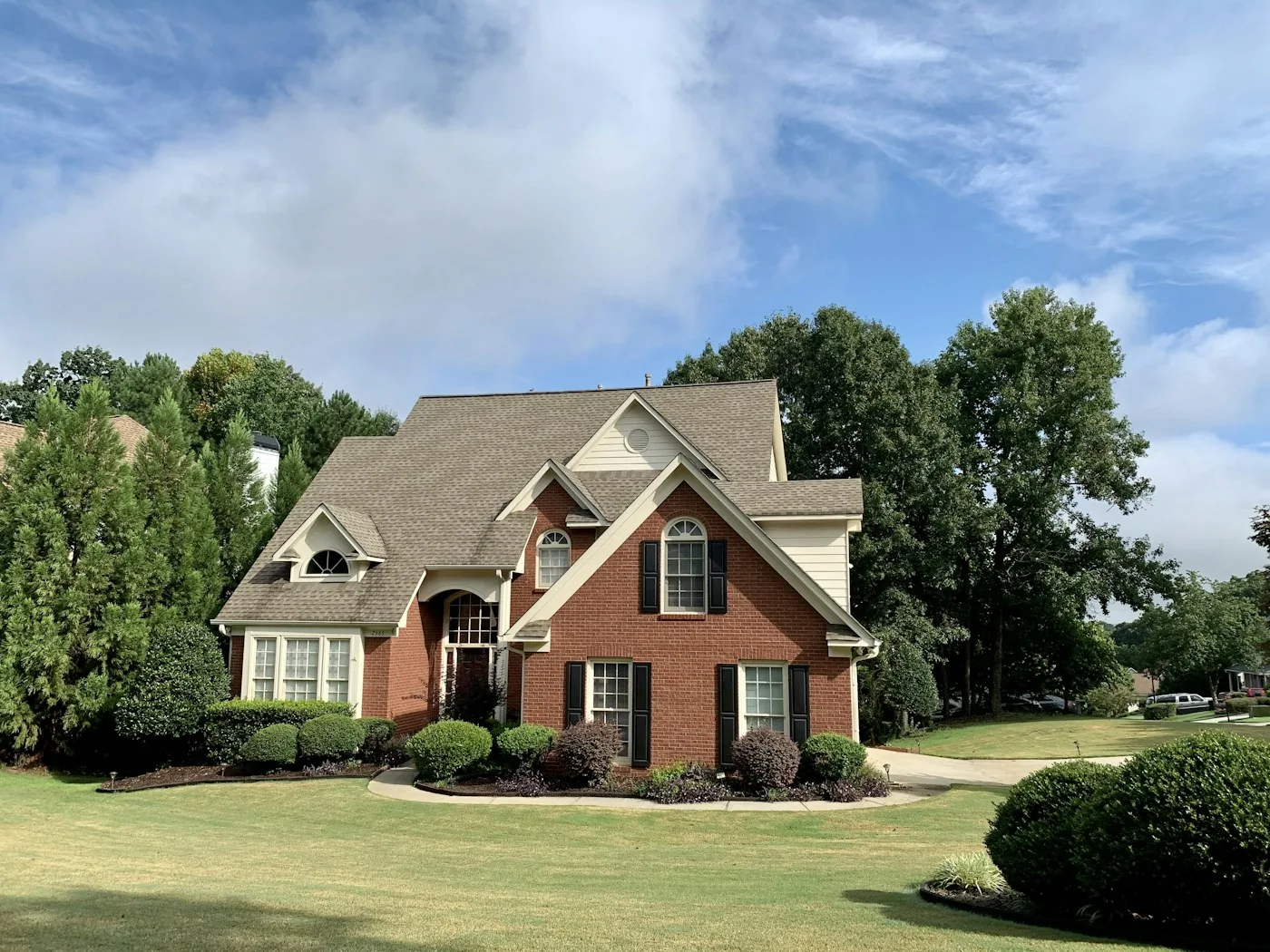 The same home with trimmed shrubs, fresh mulch and a crisp lawn